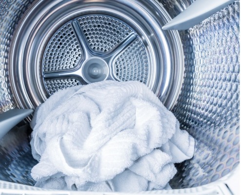 dryer interior with white laundry