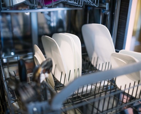 open dishwasher with dishes in racks