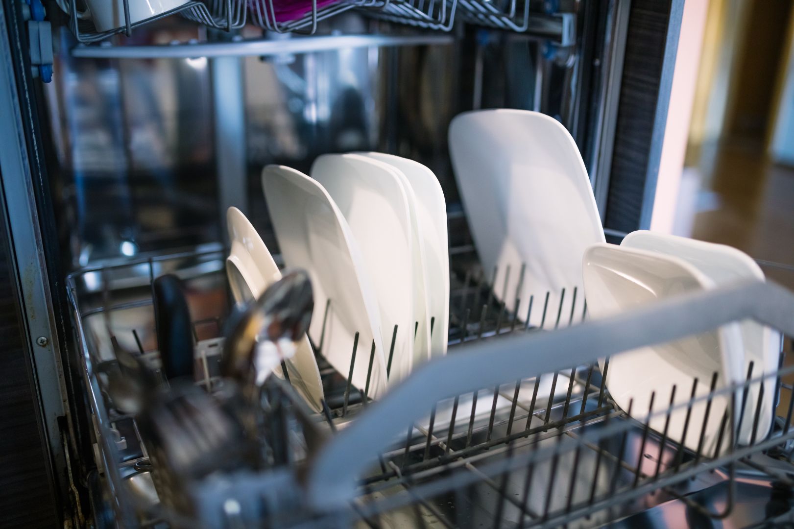 open dishwasher with dishes in racks