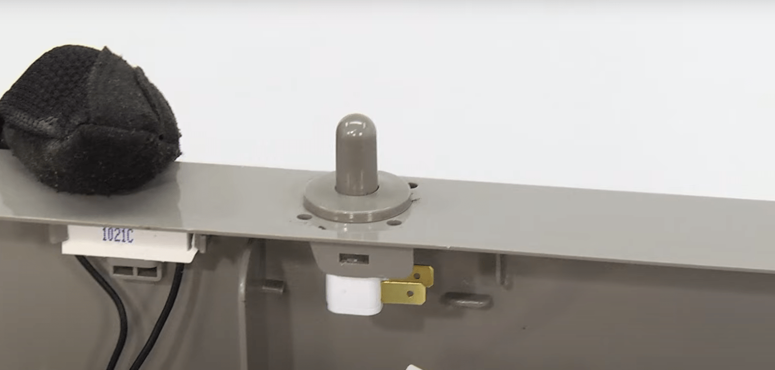 Door switch on a refrigerator being replaced